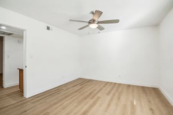 A room with a ceiling fan and wooden flooring. at The Viridian Apartments, Scottsdale 85250